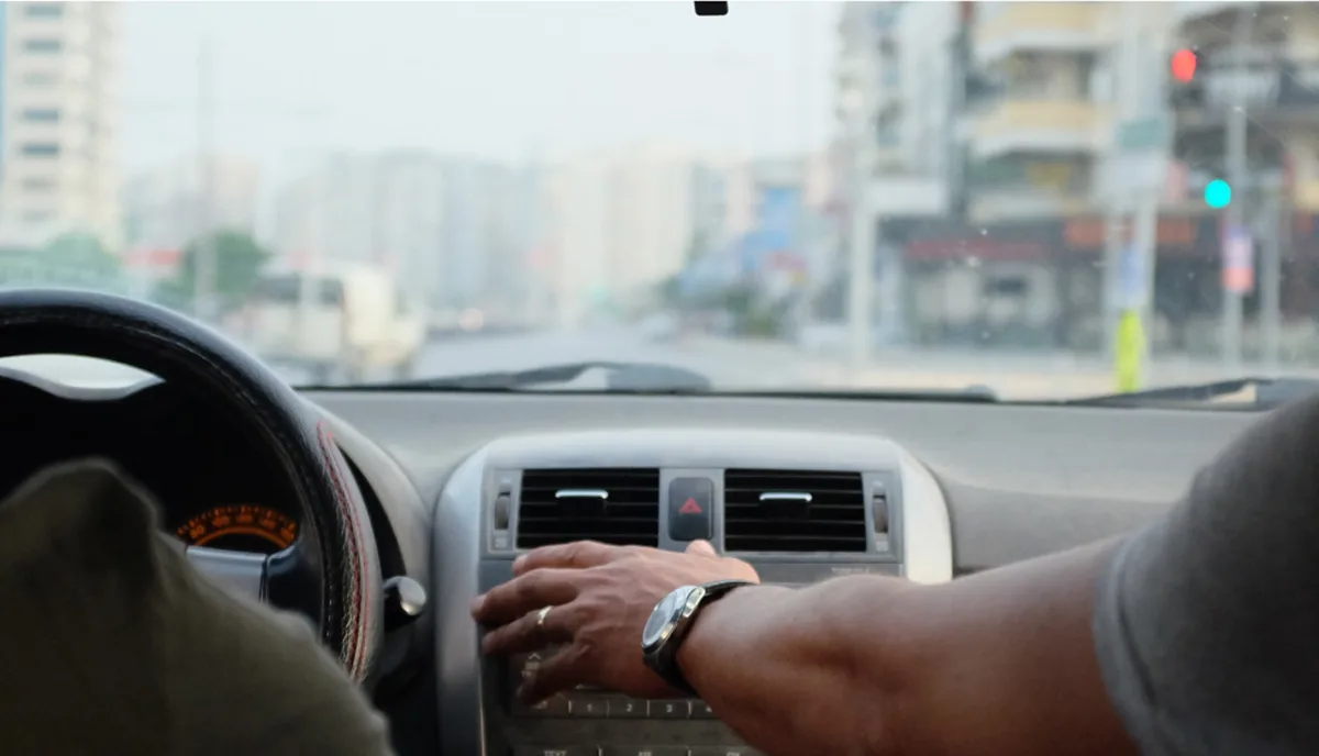 View from the passenger seat of a car driving through city streets